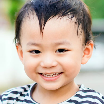 smiling asian boy outdoor at a Preschool & Daycare Serving Conway & Myrtle Beach, SC