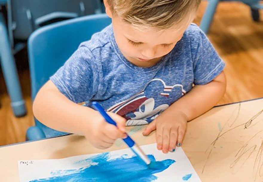 cute boy drawing with markers at a Preschool & Daycare Serving Conway & Myrtle Beach, SC