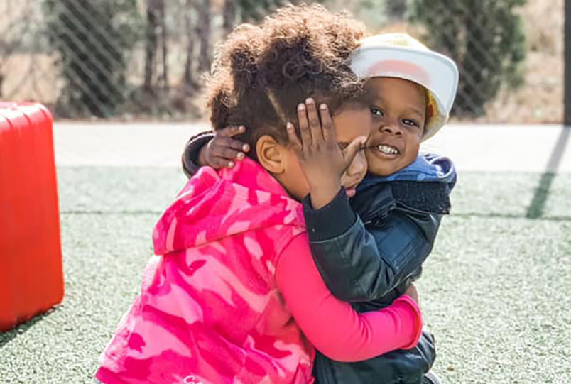 happy preschool girls hugging at a Preschool & Daycare Serving Conway & Myrtle Beach, SC