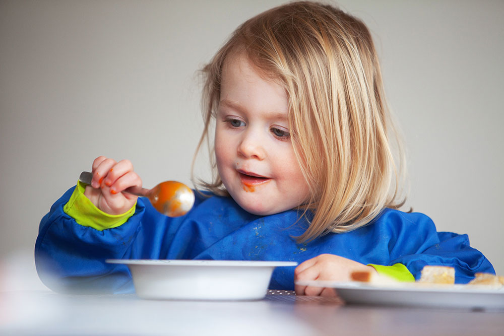 young girl eating tomato soup at a Preschool & Daycare Serving Conway & Myrtle Beach, SC