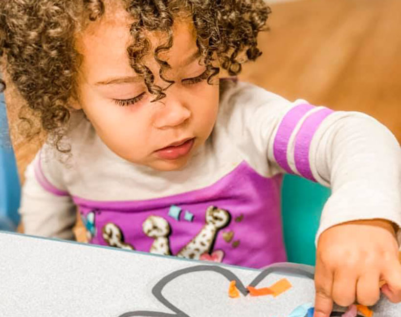 cute toddler finger painting at a Preschool & Daycare Childcare Center serving Conway & Myrtle Beach, SC